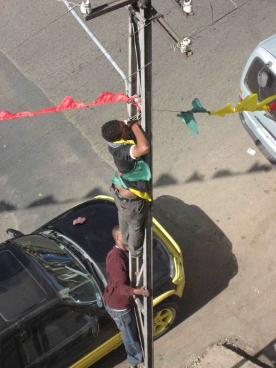 Stringing bunting from street pole