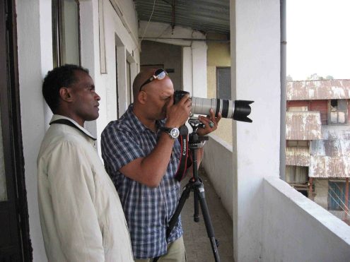 Toni and assistant photographing from Billy’s balcony